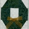 greath wreath quilt block with gold bow