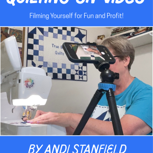 book cover shows a woman at a sewing machine behind a camera on a tripod. Title is Quilting on Video, Filming Your Craft for Fun and Profit by Andi Stanfield, star of @TrueBlueQuilts